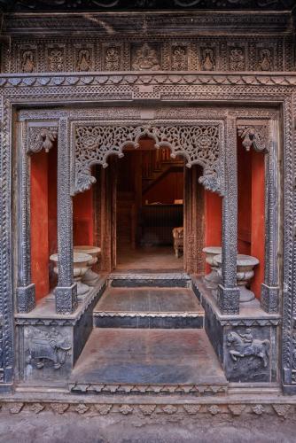 an entrance to a building with red walls and pillars at Kaladwas Lal Haveli - A Heritage Boutique Hotel in Udaipur