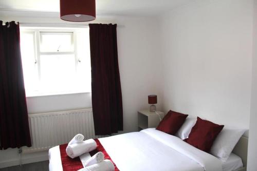 a bedroom with a white bed and a window at Coolfin House - London Excel in London