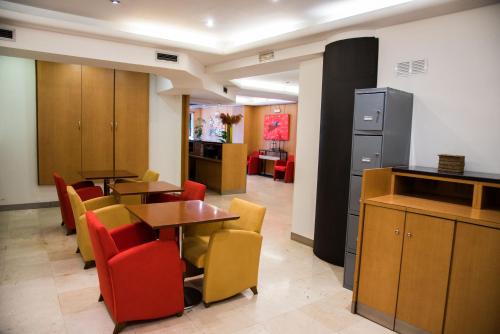 a restaurant with tables and chairs in a room at Hotel Delta in Tudela