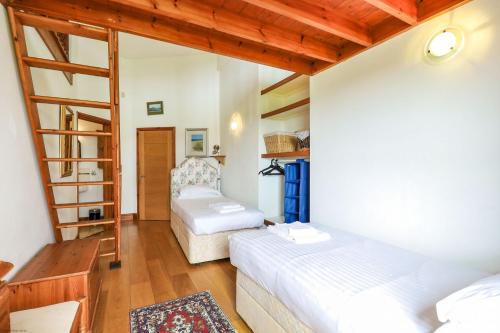 a bedroom with two beds and a ladder at The Old Signal House in Niton