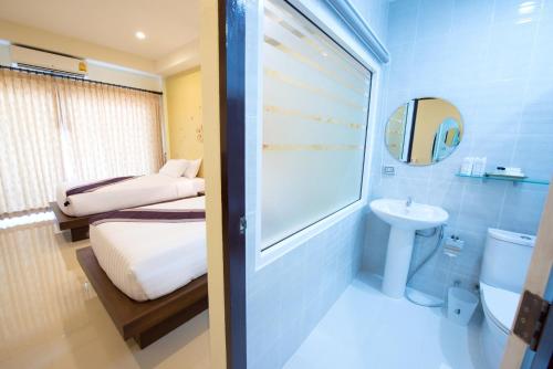 
a bathroom with a toilet, sink, and bathtub at Maryo Resort - SHA Plus in Chiang Rai
