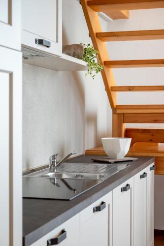 a kitchen with a sink and a counter top at Villa Raggi Relais in Castelletto d'Orba