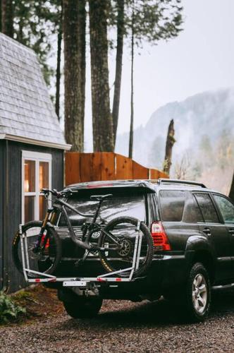 a bike on the back of a black truck at Persis tiny cabin. amazing outdoor shower. in Sultan