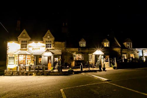 ein Gebäude mit Lichtern in der Nacht in der Unterkunft The Collyweston Slater in Collyweston