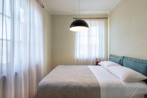 a bedroom with a bed and a large window at Villa Raggi Relais in Castelletto d'Orba