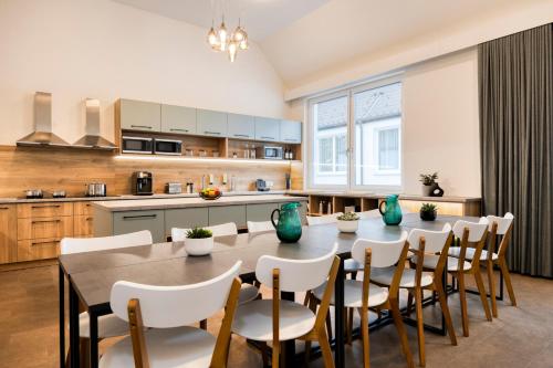 a kitchen with a table and chairs in a kitchen at lyf Schönbrunn Vienna in Vienna