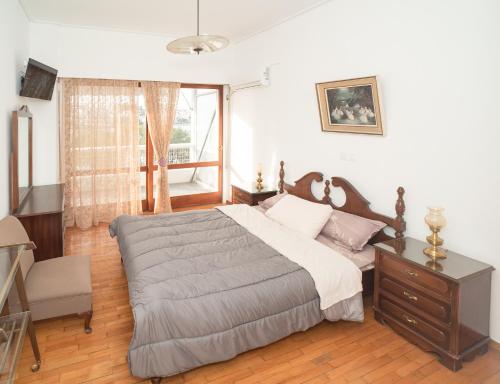 a bedroom with a large bed and a window at GDsuites in Chalkida