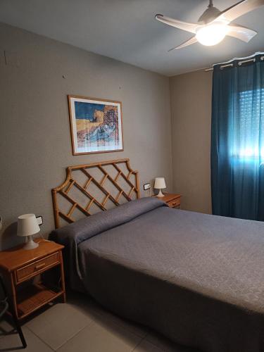 a bedroom with a bed and a ceiling fan at Somni Cambrils in Cambrils