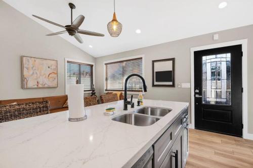 a kitchen with a sink and a ceiling fan at The Zen Den Your Luxury Vacay Awaits in San Diego