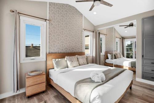 a bedroom with two beds and two windows at The Zen Den Your Luxury Vacay Awaits in San Diego