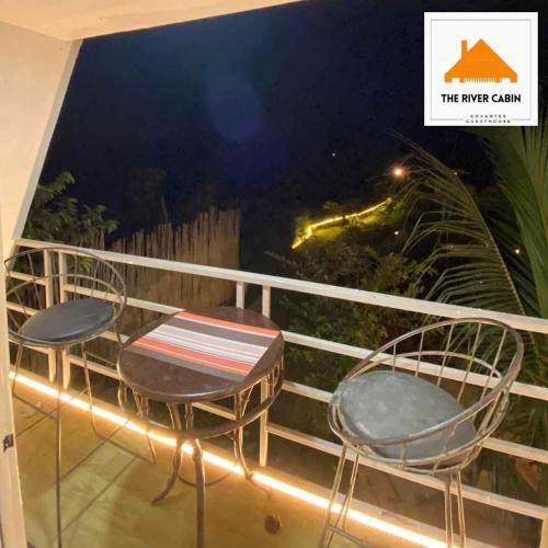 a balcony with two chairs and a table at The River Cabin - Govantes Guesthouse in San Vincente