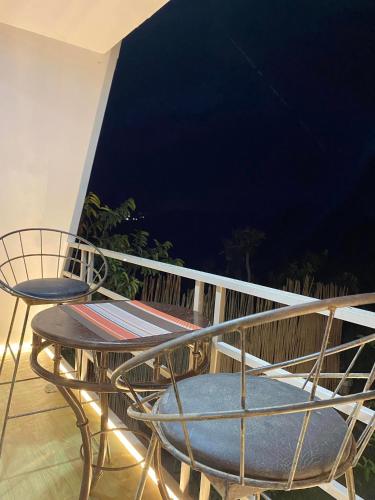 a balcony with a table and chairs on a balcony at The River Cabin - Govantes Guesthouse in San Vincente