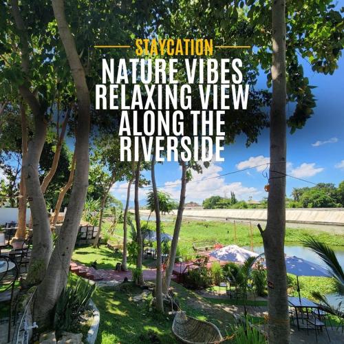 a sign that reads vacation nature videos relaxing view along the riverside at The River Cabin - Govantes Guesthouse in San Vincente