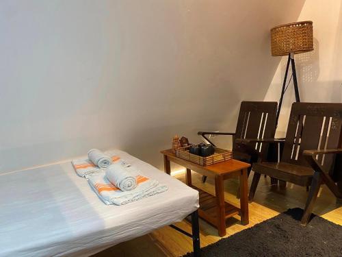 a room with a bed and a table and chairs at The River Cabin - Govantes Guesthouse in San Vincente