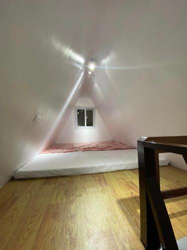a bed in a room with a ceiling fan at The River Cabin - Govantes Guesthouse in San Vincente