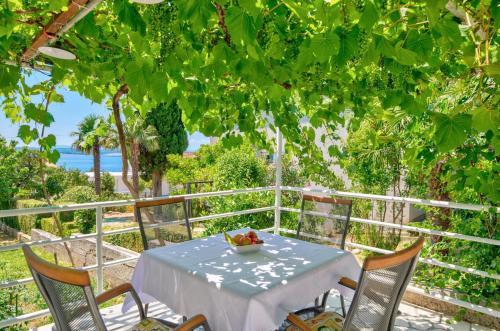 a table and chairs with a bowl of fruit on it at Apartments in Crikvenica 41682 in Crikvenica