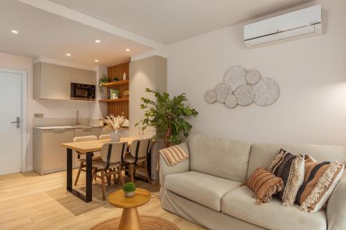 a living room with a couch and a table at Marconia Boutique Residence in L'Estartit