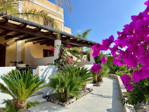 a house with pink flowers in front of it at Villa Saraceno in Lipari