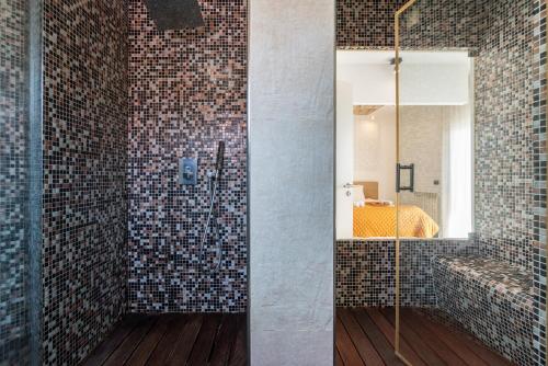 uma casa de banho com um chuveiro com um espelho e um quarto em Host Wise - Luxurious House with Private Salt Pool em Ferragudo