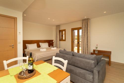 een woonkamer met een bank en een bed bij Niriides Luxury Villas in Methoni