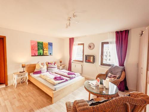 a bedroom with a bed and a living room at Zi2 - Urlaubsmagie - Flussblickwohnung mit Whirl-Pool& Sauna in Sebnitz