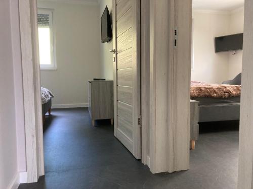 a room with a bedroom with a bed and a door at Lux Faház in Parád