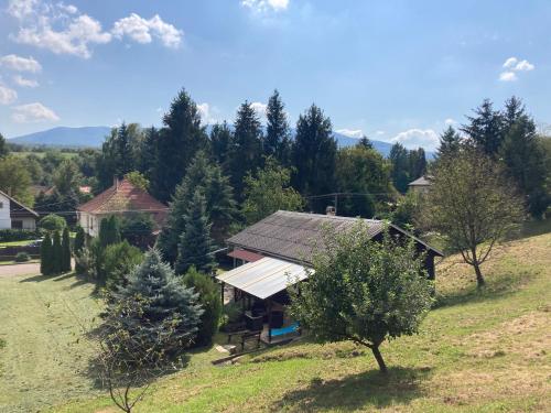 a small house on a hill with trees in a field at Lux Faház in Parád