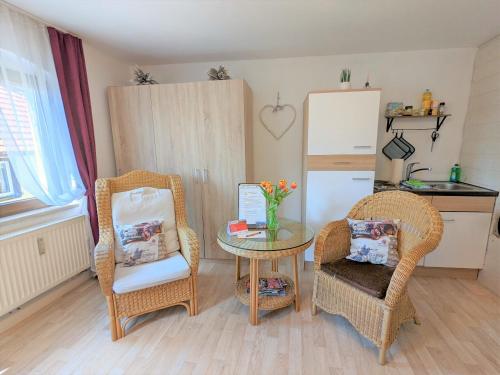 a living room with two chairs and a table and a tableablish at Zi2 - Urlaubsmagie - Flussblickwohnung mit Whirl-Pool& Sauna in Sebnitz