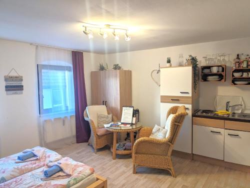 a room with a bed and a table with chairs at Zi2 - Urlaubsmagie - Flussblickwohnung mit Whirl-Pool& Sauna in Sebnitz