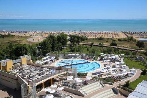 a view of a resort with a pool and a beach at Laguna Park Hotel 4Superior in Bibione