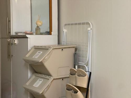 a bathroom with a toilet with three drawers at Serein_HongDae in Seoul