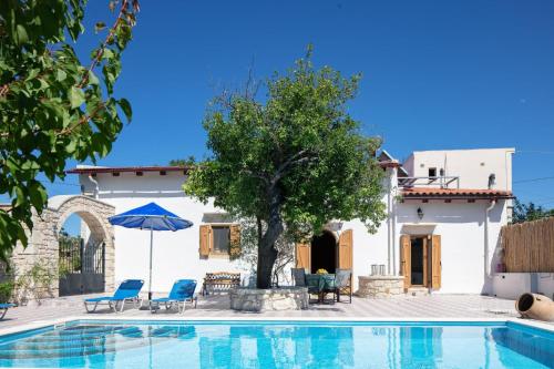 a villa with a swimming pool and a house at Silver Gem Villa with private pool in Gerani