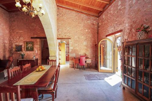 a dining room with a table and chairs in a building at Silver Gem Villa with private pool in Gerani