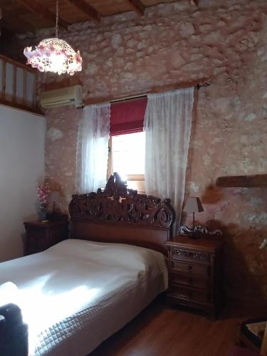 a bedroom with a bed and a window at Silver Gem Villa with private pool in Gerani