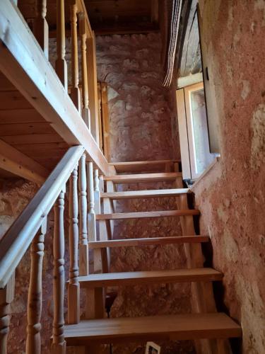 a staircase in an old house with wooden steps at Silver Gem Villa with private pool in Gerani
