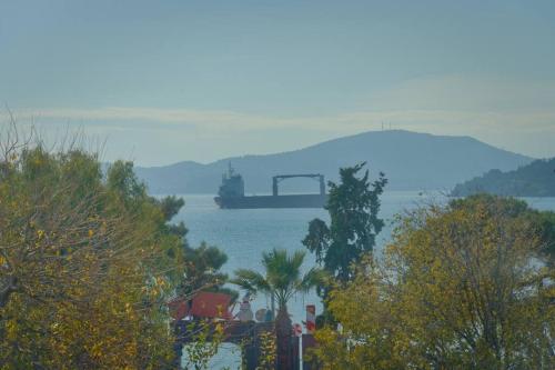 a large container ship in a large body of water at Sunset city apartment in Volos
