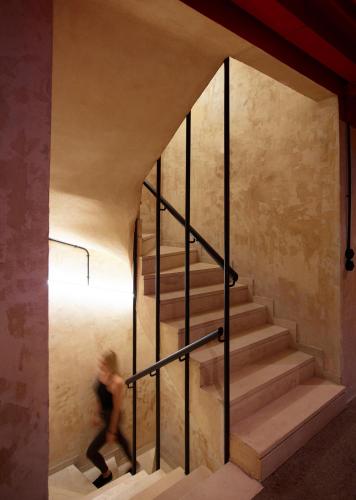 a person walking down the stairs of a house at Dave Red Athens, a member of Brown Hotels in Athens