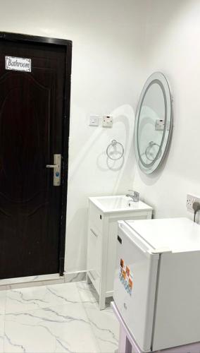 a bathroom with a black door and a mirror at 1bedroom serviced apartment in Benin City in Benin City