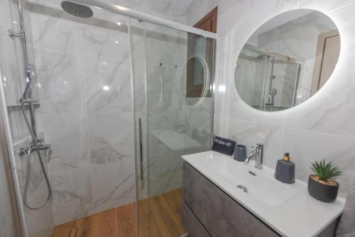 a bathroom with a shower and a sink and a mirror at Villa Sunset in Samos