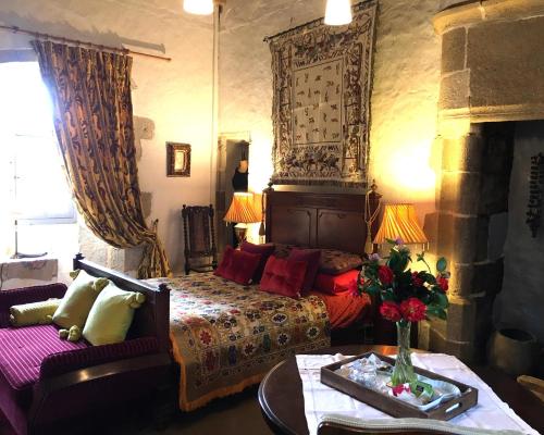 a bedroom with a bed and a couch at Chateau Mareuil in Brigueuil-le-Chantre