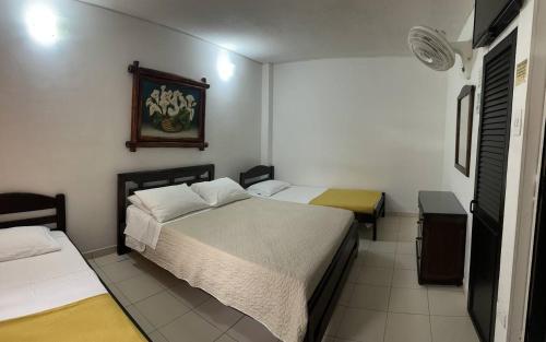 Una cama o camas en una habitación de Hotel Campestre Villa Yudy