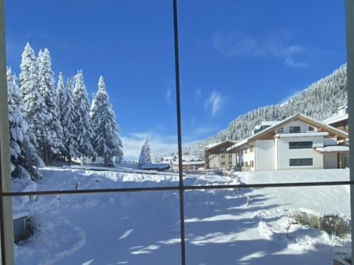 a view from a window of a snow covered yard at Haus Mees in Königsleiten