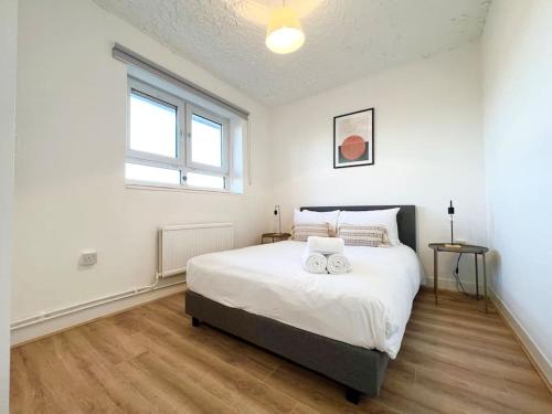 a bedroom with a large bed with two mugs on it at 2 Bed- Belsize Park in London