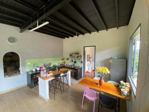 a kitchen with a table and chairs in a room at Lam Nguyên Farm Stay in Bao Loc