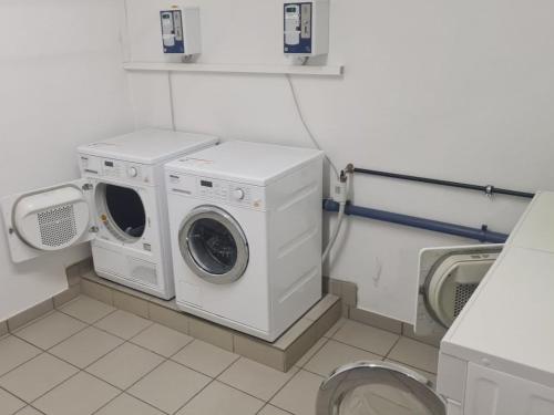 a laundry room with a washing machine and a toilet at Haus Mees in Königsleiten