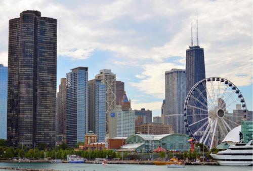 a city with a ferris wheel in front of tall buildings at La Quinta by Wyndham Chicago Downtown in Chicago