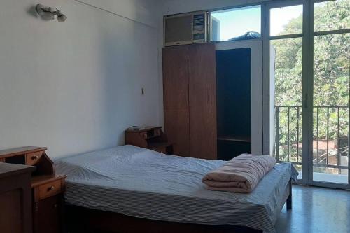 a bedroom with a bed and a large window at Departamento céntrico in San Lorenzo