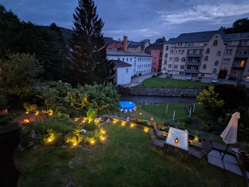 a view of a garden at night with lights at Zi2 - Urlaubsmagie - Flussblickwohnung mit Whirl-Pool& Sauna in Sebnitz