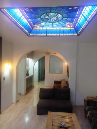 a living room with a couch and a stained glass ceiling at LA CASA DEL NARANJO in Mexico City