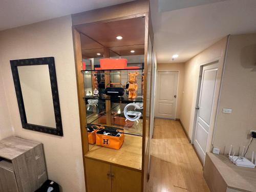a room with a closet with a mirror and a hallway at 2bd Apartment near icon Siam close to Everything in Bangkok